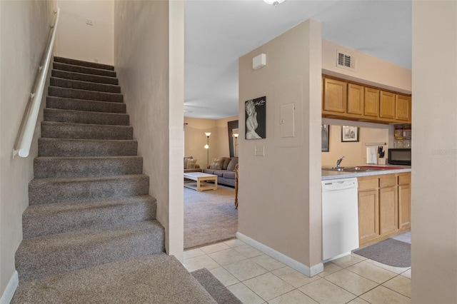 stairs with sink and tile patterned flooring