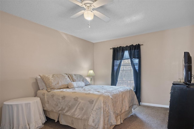 carpeted bedroom with ceiling fan and a textured ceiling