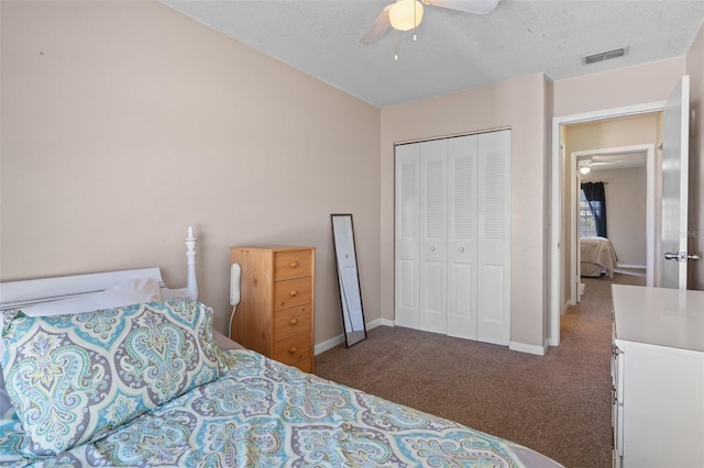 carpeted bedroom with a textured ceiling, a closet, and ceiling fan