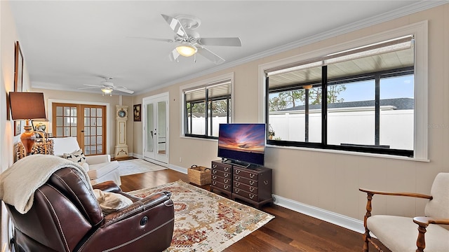 living room with french doors, crown molding, dark wood-type flooring, a ceiling fan, and baseboards