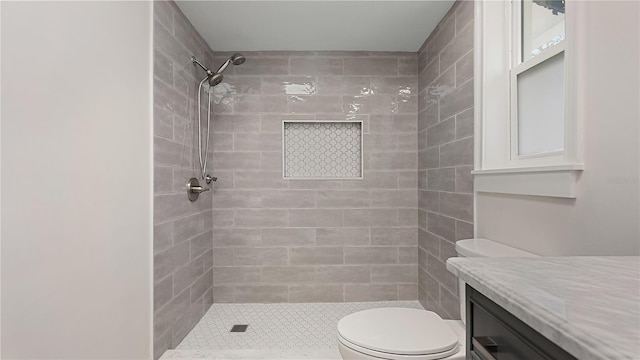 full bath featuring vanity, a shower stall, and toilet