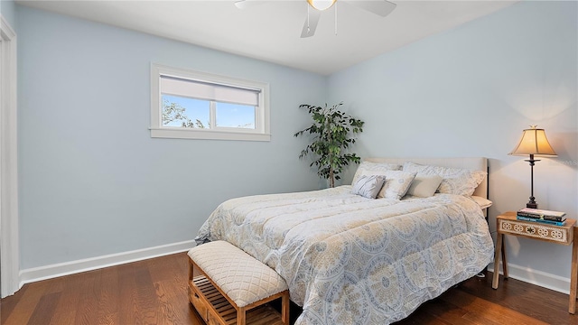 bedroom with a ceiling fan, baseboards, and dark wood-type flooring