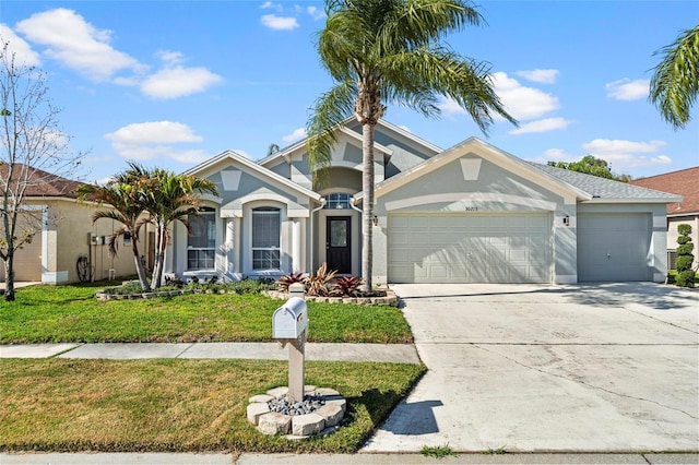 view of front of home featuring a front lawn and a garage