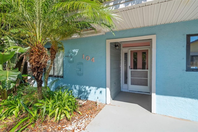 104 Anclote Rd Unit 104, Tarpon Springs, FL 34689 - doorway to property with stucco siding