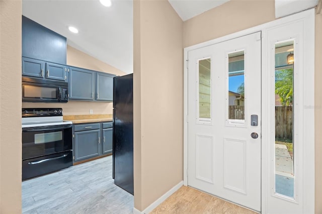 kitchen with baseboards, blue cabinetry, light wood-style flooring, black appliances, and light countertops