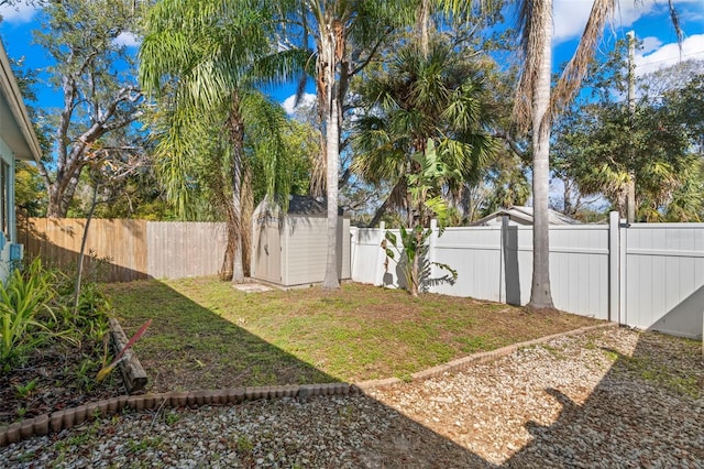 view of yard with a storage unit, an outdoor structure, and a fenced backyard