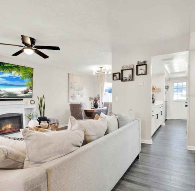 living room featuring ceiling fan and dark hardwood / wood-style flooring