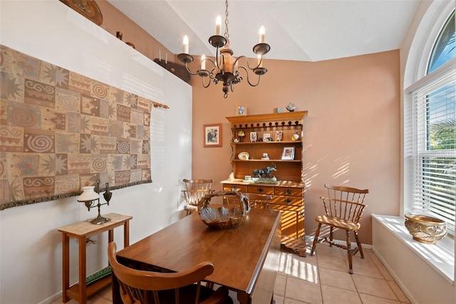 dining space featuring light tile patterned floors, baseboards, and a notable chandelier