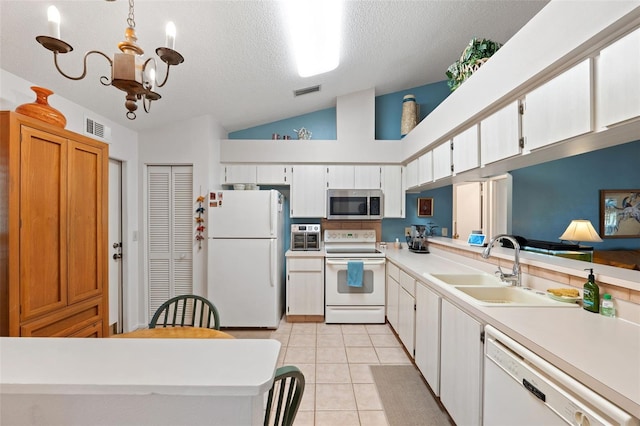 kitchen with white appliances, visible vents, light countertops, white cabinetry, and pendant lighting