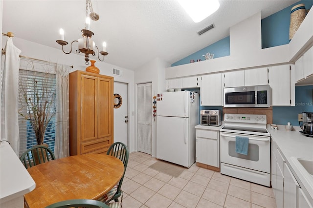 kitchen featuring light countertops, white appliances, visible vents, and white cabinets