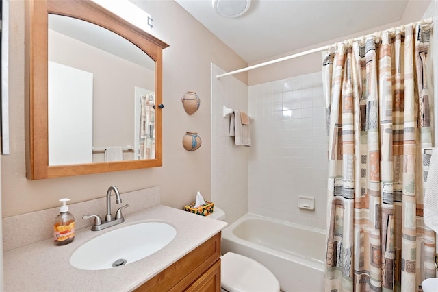 bathroom featuring toilet, shower / tub combo, and vanity