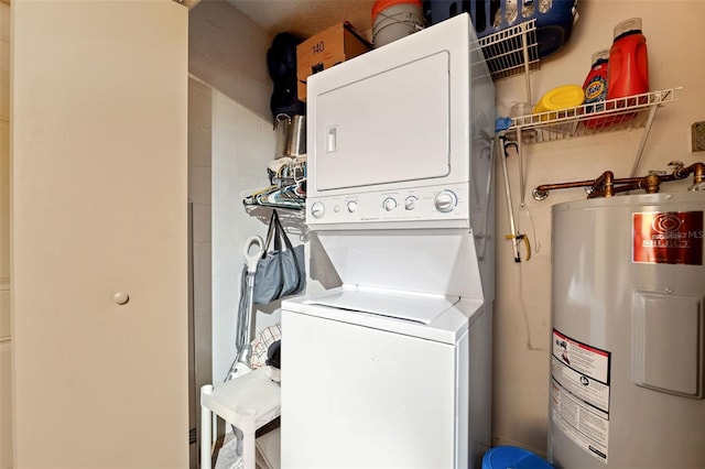 laundry area featuring stacked washer and dryer, laundry area, and water heater