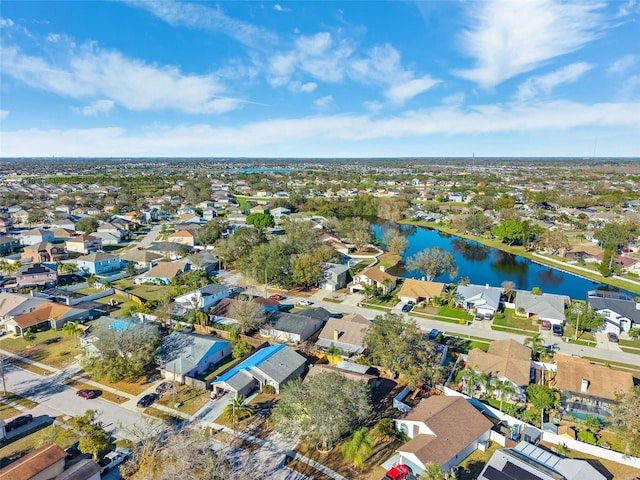 drone / aerial view with a residential view and a water view