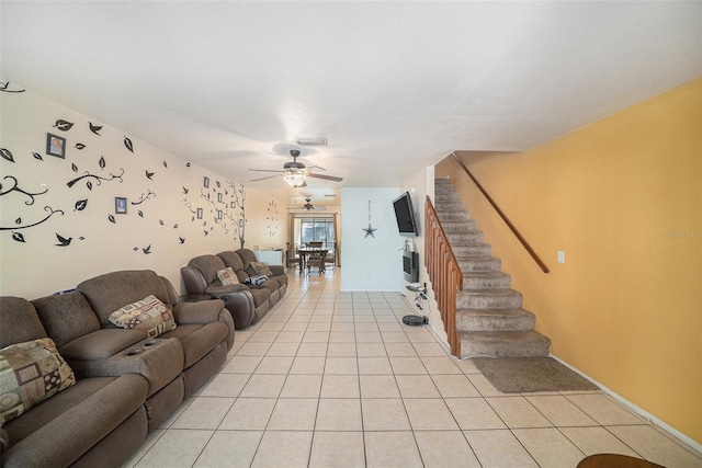 living area featuring light tile patterned floors, visible vents, stairway, and a ceiling fan