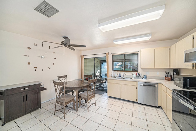 kitchen featuring light tile patterned floors, light countertops, visible vents, a ceiling fan, and black appliances