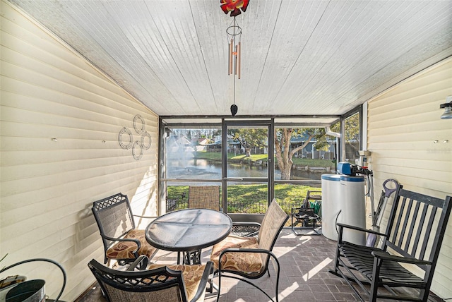 sunroom / solarium featuring a water view, wood ceiling, and vaulted ceiling