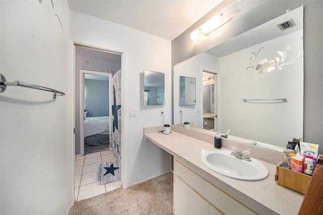 ensuite bathroom with visible vents, connected bathroom, and vanity