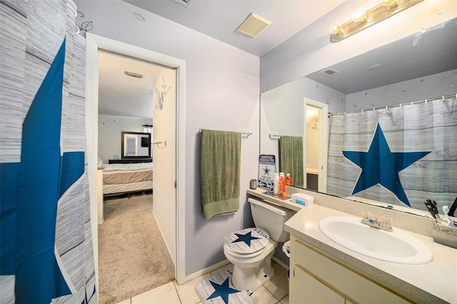 ensuite bathroom featuring visible vents, toilet, ensuite bathroom, vanity, and tile patterned flooring