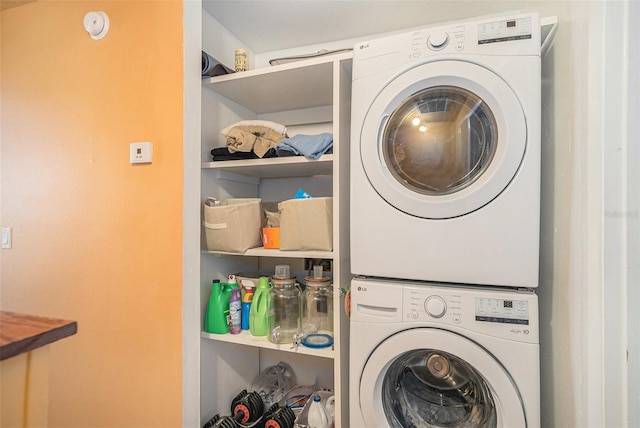 laundry area featuring stacked washer / drying machine