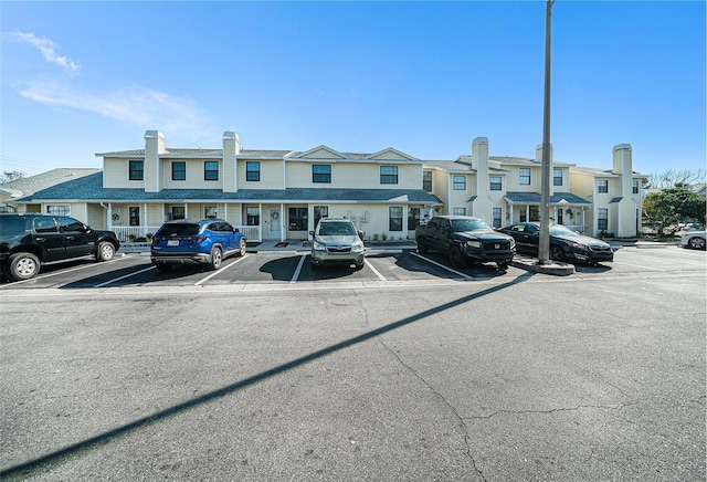 uncovered parking lot featuring a residential view