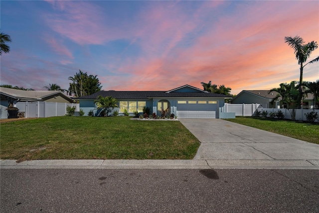 single story home featuring fence, stucco siding, a front lawn, concrete driveway, and a garage