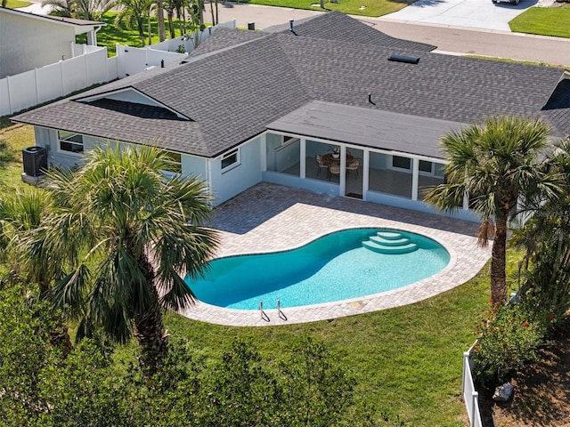 pool with a fenced backyard, a patio, and a yard