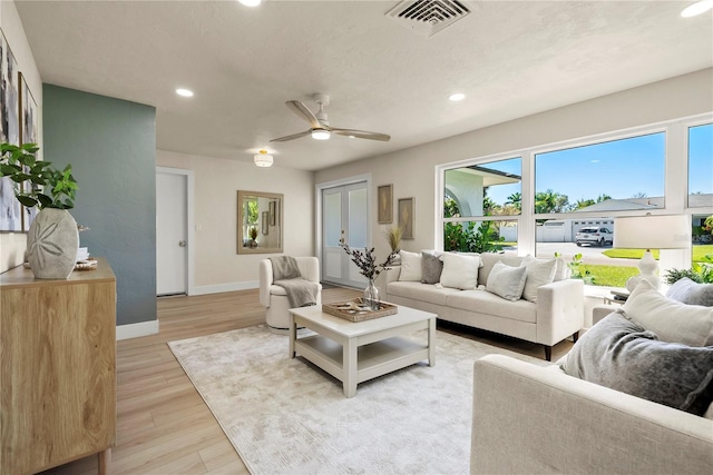 living area featuring baseboards, visible vents, light wood finished floors, recessed lighting, and ceiling fan