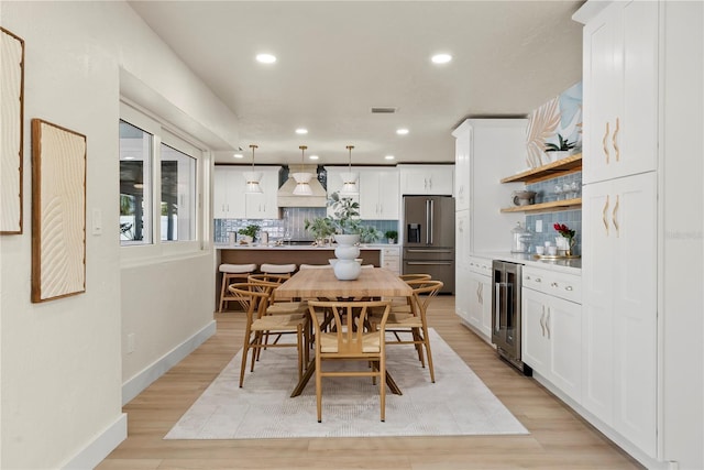 dining space featuring beverage cooler, visible vents, recessed lighting, and light wood finished floors