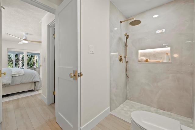 ensuite bathroom featuring toilet, a ceiling fan, ensuite bath, wood finished floors, and tiled shower