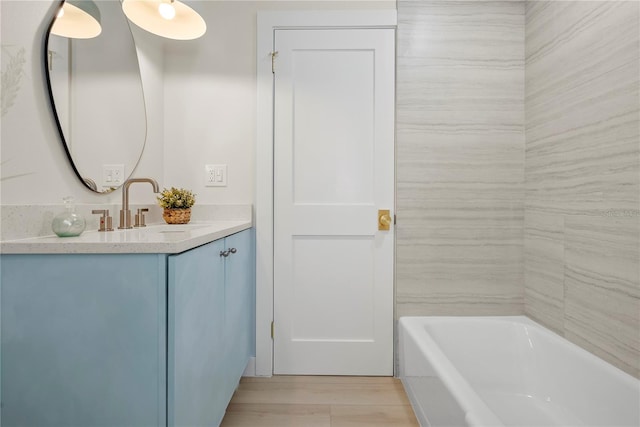 full bath featuring a bathing tub and vanity