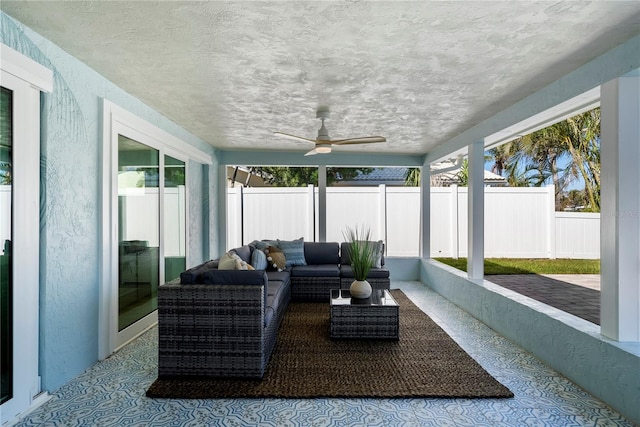 sunroom / solarium featuring ceiling fan