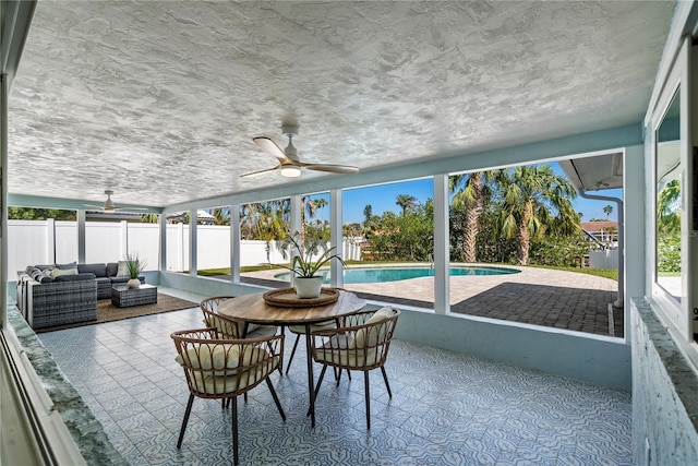 sunroom / solarium with plenty of natural light and ceiling fan