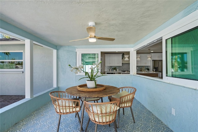 sunroom with a ceiling fan