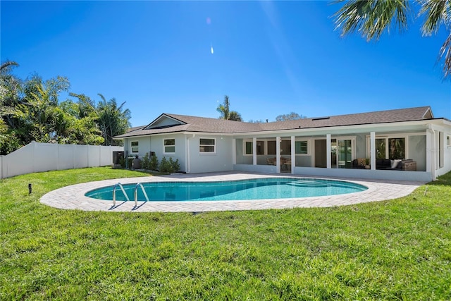 view of pool featuring a fenced in pool, a sunroom, a fenced backyard, a yard, and a patio area