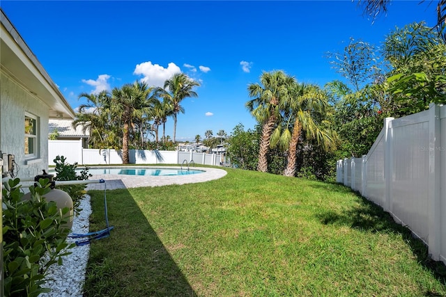 view of yard featuring a fenced in pool and a fenced backyard