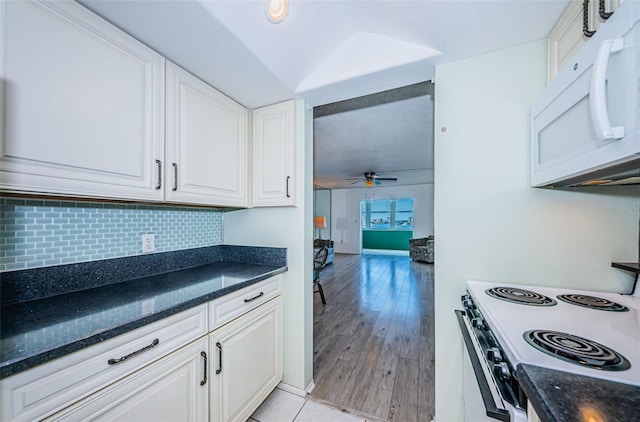 kitchen with ceiling fan, white cabinets, range with electric stovetop, and white microwave