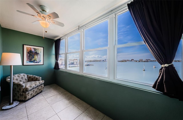 interior space featuring a water view and a ceiling fan