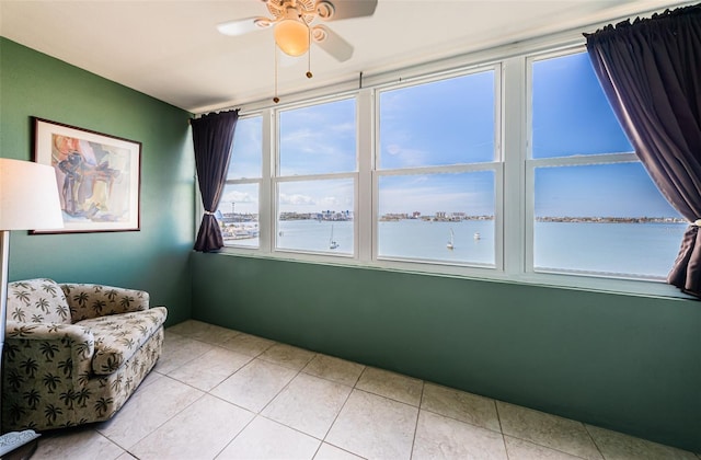 interior space featuring a water view and a ceiling fan