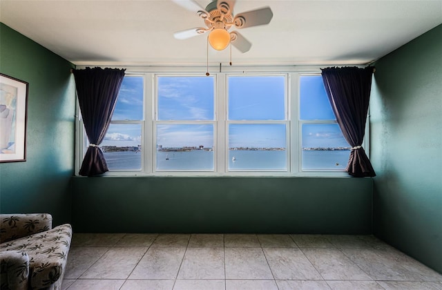 unfurnished room featuring a wealth of natural light and ceiling fan