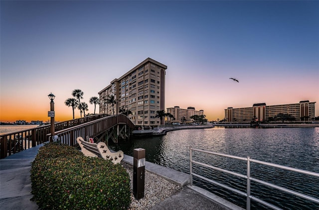 view of dock featuring a view of city and a water view