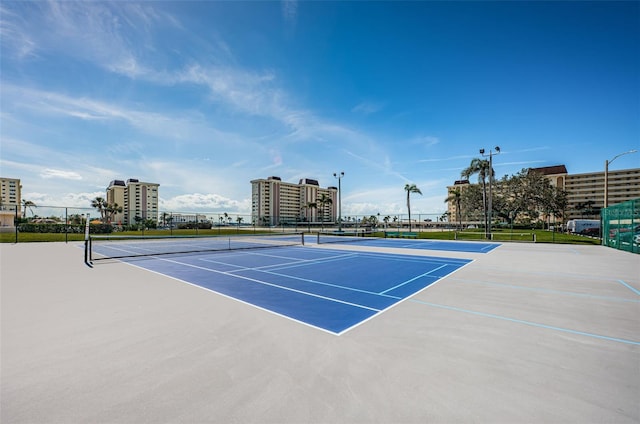 view of sport court with a view of city and fence