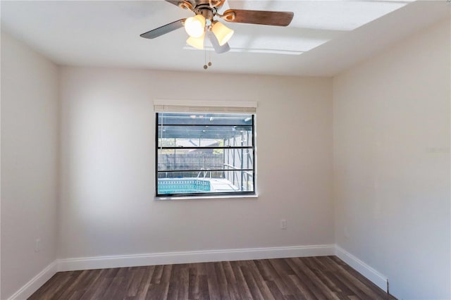 empty room with ceiling fan, baseboards, and wood finished floors