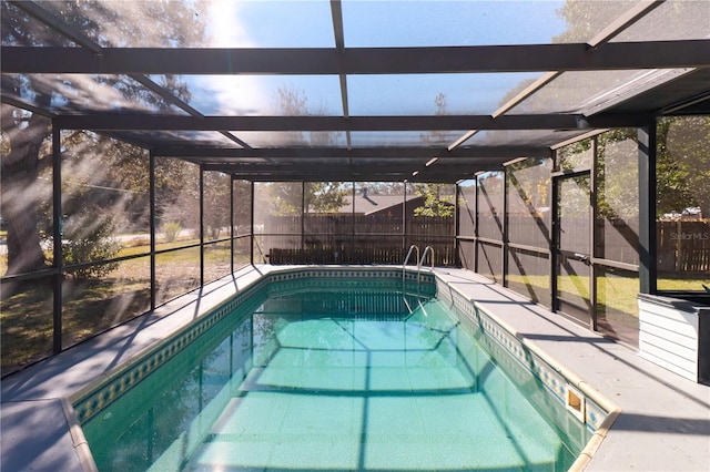 view of swimming pool featuring a fenced in pool, glass enclosure, a fenced backyard, and a patio