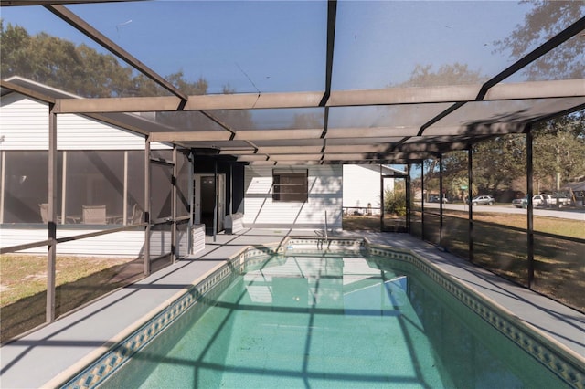 outdoor pool with a lanai and a patio