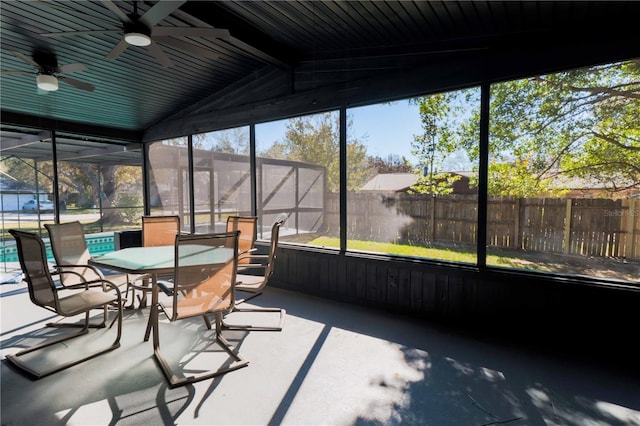 sunroom / solarium with vaulted ceiling and a ceiling fan