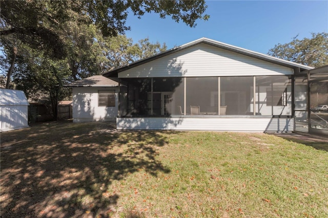 back of house featuring a sunroom, a yard, and fence