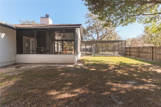 view of yard with a sunroom and a fenced backyard