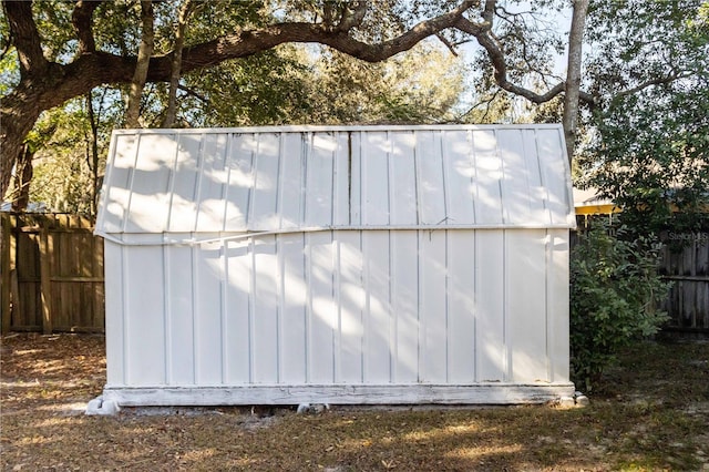 view of shed featuring fence