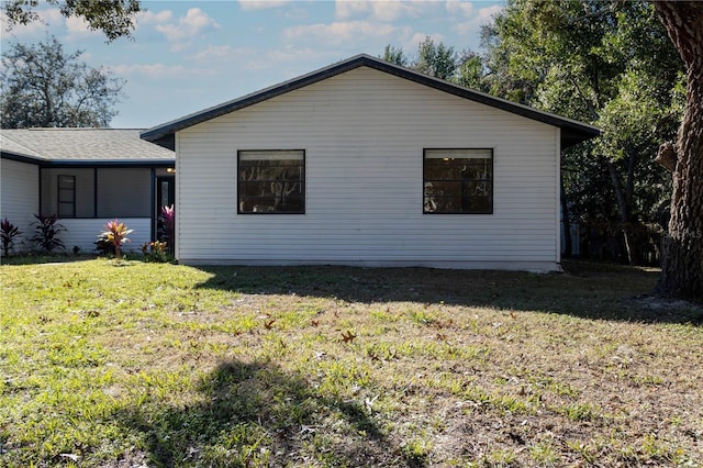 view of home's exterior with a lawn