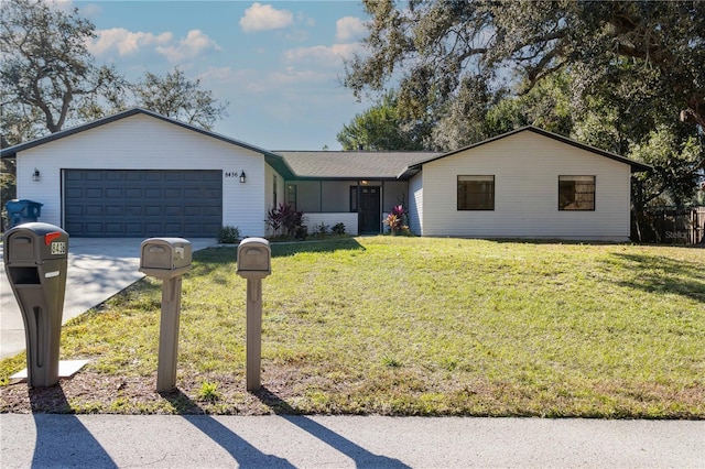 ranch-style home with a front lawn, concrete driveway, and an attached garage